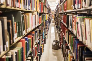View down a row of bookshelves in a library