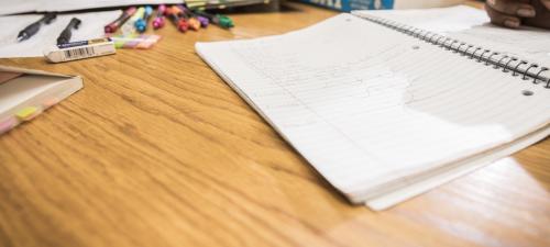Photo of notebooks and pens on a table top